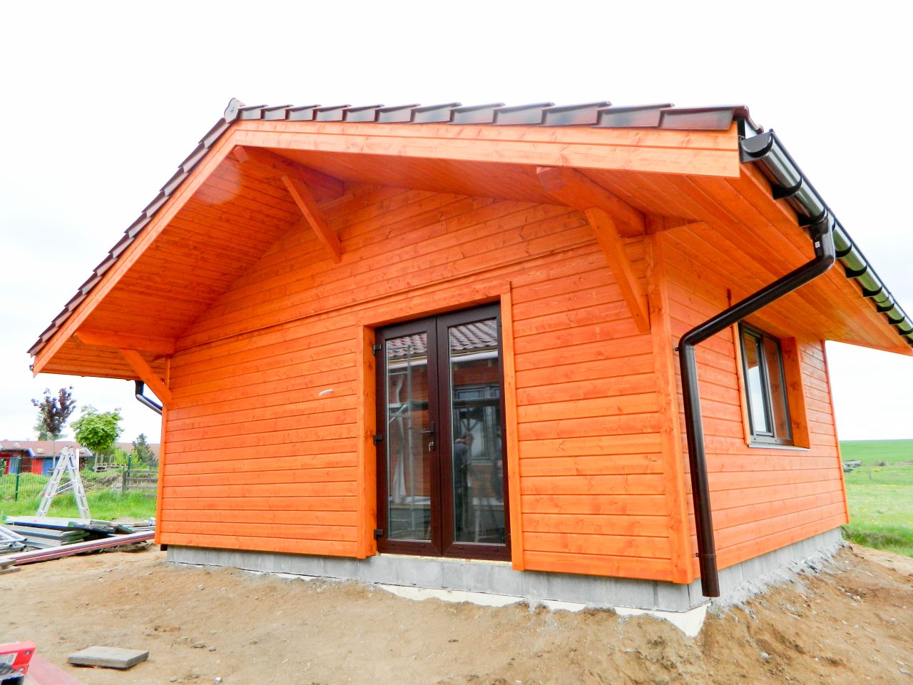 Close-up of timber cladding and overhanging roof structure on the completed house.